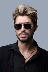 Close-up portrait of handsome stylish man in sunglasses.