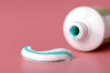 Tooth paste close up on pink background