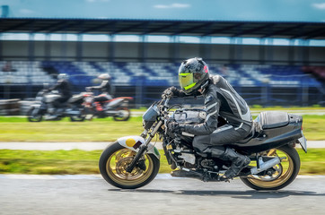 Motorcycle racer on sportbike leaning into a fast corner on track