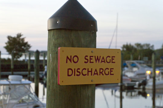 Bright Warning Sign On Dock Says No Sewage Discharge