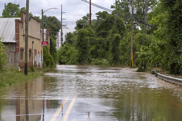 Fototapeta na wymiar River Overflows Flooding a Road