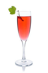 Red drink or cocktail in a glass for champagne isolated on white with red currant