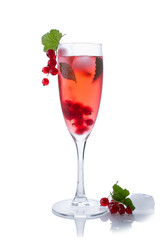 Red drink or cocktail in a glass for champagne isolated on white with red currant