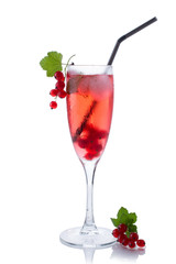 Red drink or cocktail in a glass for champagne isolated on white with red currant