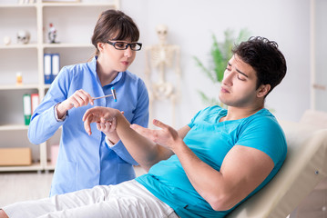 Doctor checking nerve reflexes with hammer