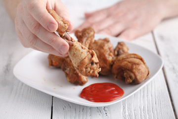 Eat unhealthy fry chicken leg with ketchup