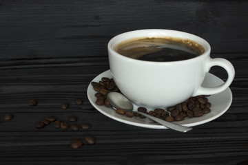 coffee in a white cup, spoon, coffee beans