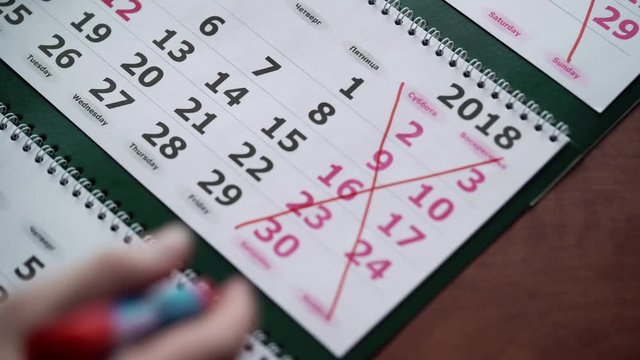 Crossing weekend dates in calendar with red pen