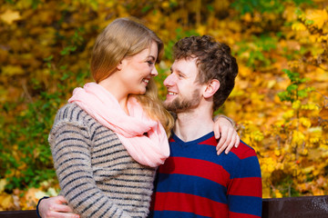 Fototapeta premium Lovers couple in autumn park on bench