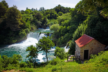 Fototapeta na wymiar Waterfalls and a stone mill in the Krka National Park, Croatia