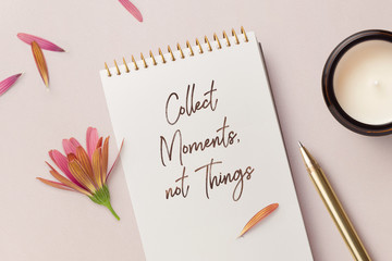 collect moments, not things - motivational / inspirational quote written on a notepad, top view of...