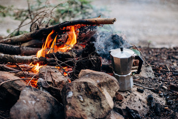 Cooking coffee on a campfire at a summer camp.