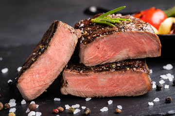 Close-up of steak Top Blade roasting medium ready to eat on dark stone background