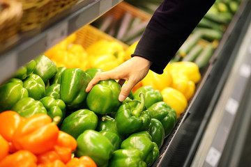Young man buying vegetables at the market