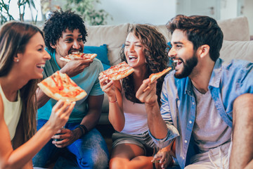 Group of young friends eating pizza.Home party.
