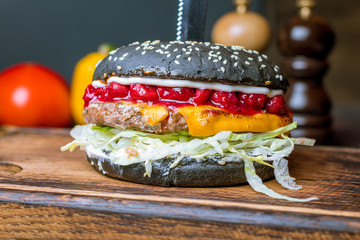 Black Burger with meat and cherry