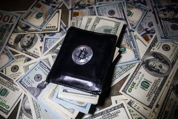 golden bitcoin coin on us dollars close up