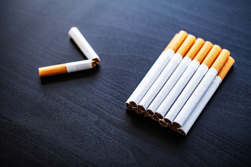 Stop smoking concept on background with broken cigarettes. Heap of cigarettes. No smoking