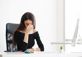 Pain. Depressed Business Woman. Beautiful Young Girl Sits in The Office at The Table and Holds Her Hands Near Her Head.