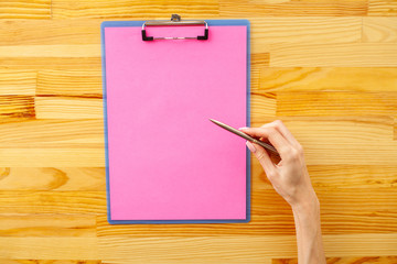 Blank Folder with Yellow Paper. Hand that Holding Folder and Handle on Wood Background. Copyspace. Place for Text.