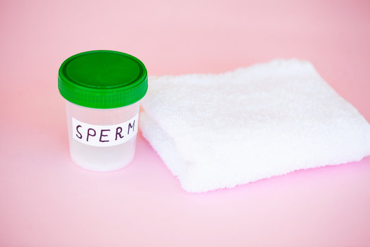 Health. Close up Sperm Analysis. Concept of Bank Sperm. Infertility Bank with Sperm on Pink Background with Towel