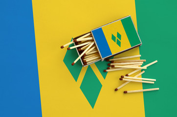 Saint Vincent and the Grenadines flag  is shown on an open matchbox, from which several matches...