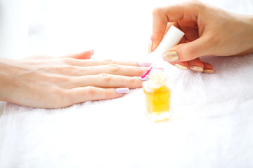SPA manicure. French manicure at spa salon. Woman hands in a nail salon receiving a manicure procedure. Manicure procedure