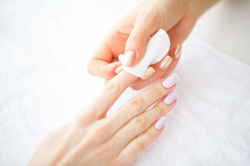 SPA manicure. French manicure at spa salon. Woman hands in a nail salon receiving a manicure procedure. Manicure procedure.