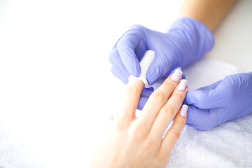 SPA manicure. French manicure at spa salon. Woman hands in a nail salon receiving a manicure procedure. Manicure procedure.