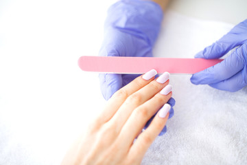 SPA manicure. French manicure at spa salon. Woman hands in a nail salon receiving a manicure...