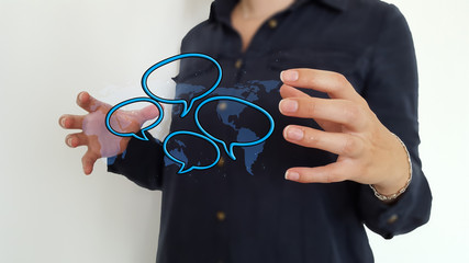 Businesswoman using hand speech bubbles over world map