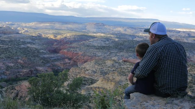 Father and son looking over a canyon together