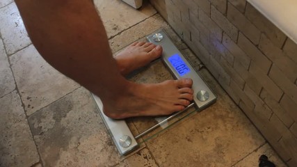 Man steps on scale and it reads 200 pounds! Scale is set
on the tile floor in a bathroom.