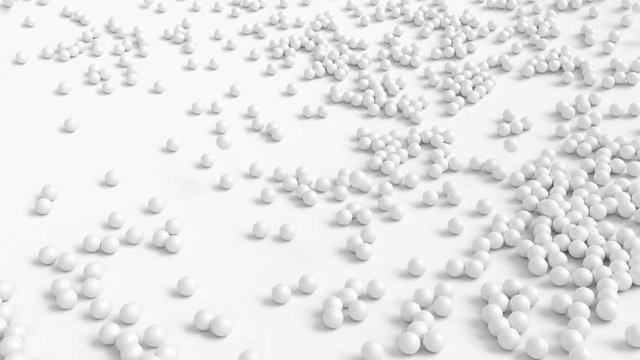 Animated falling plain white golf balls on white base or background bouncing of it and tumbling or rolling toward the center.