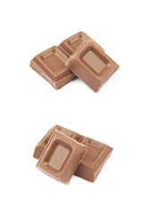 Pile of milk chocolate pieces isolated