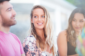 Three young friends in cafe having good time