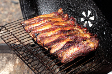 Dry rub beef ribs on the BBQ grill.