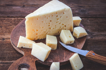 sliced cheese on a wooden board