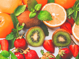 citrus fruits and strawberries on white background
