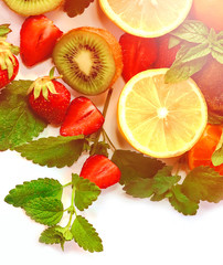 citrus fruits and strawberries on white background