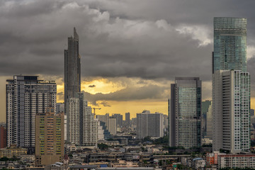 Closeup scene of bangkok cityscape with cloud when storm is coming when sunset time, Nature and city concept