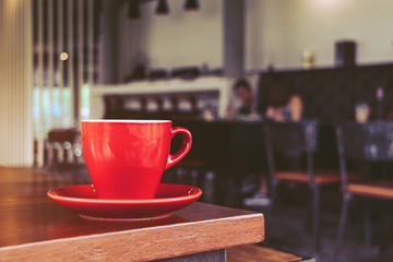 red coffee cup in cafe, on morning