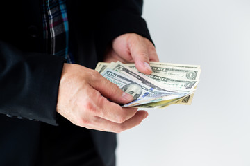Businessman giving (or paying) money, - bribery, loan and financial concepts, Selective focus