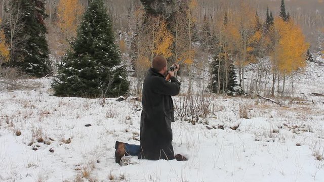 Kneeling shotgun blast in winter. 