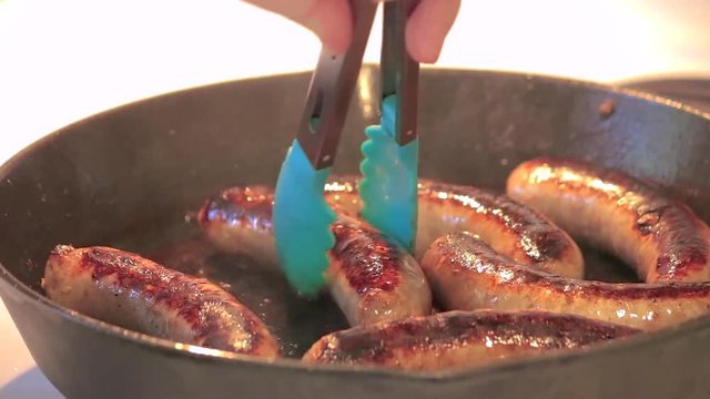 flipping bratwurst sausages