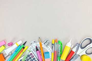 school and office stationary on grey table. flat view