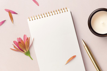 minimalist notepad mockup with flower, petals, candle and golden pen - copyspace for your text