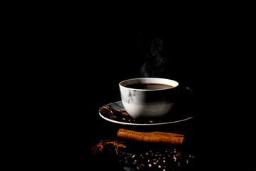 Hot black coffee cup on a black background.