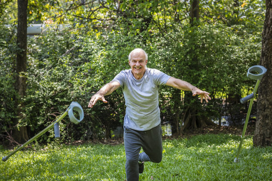 Rehabilitated Senior Man Throwing His Crutches