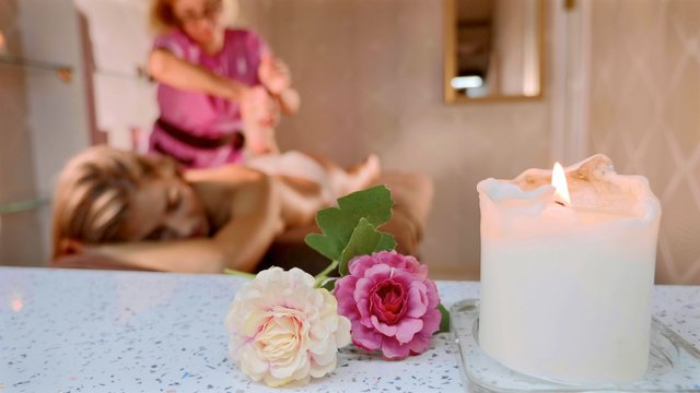 Massage concept. Beautiful young woman reciving relaxing massage at spa salon